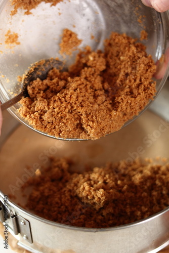 Transfer cookies mixture into baking pan. Making frozen strawberry cheesecake series.