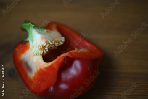 Close-up of a sliced red bell pepper cut into halves. The seeds are shown. 