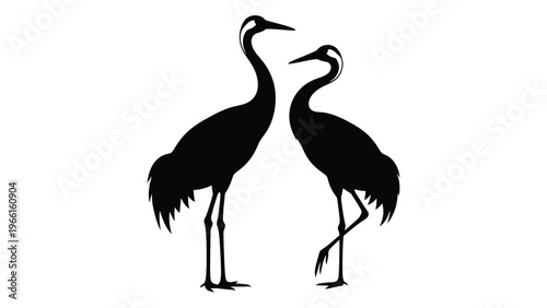Two elegant cranes facing each other in a minimalist black silhouette design