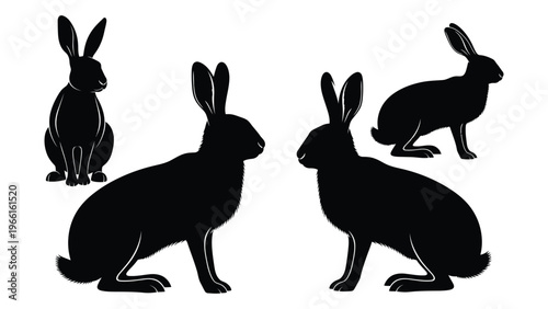 Black silhouettes of four rabbits in various sitting and alert poses