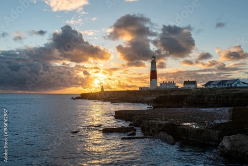 Photo of the sun setting at Portland Bill lighthouse in Dorset