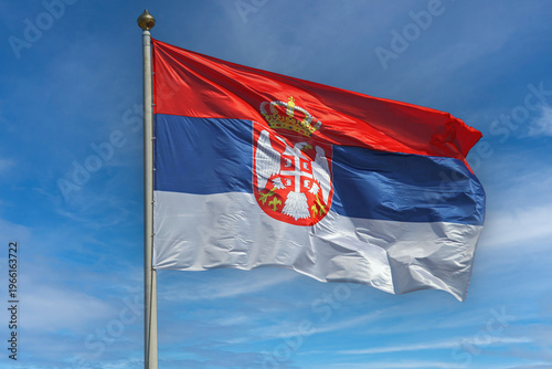 Official Serbian Flag With Coat of Arms at Windy Sunny Day