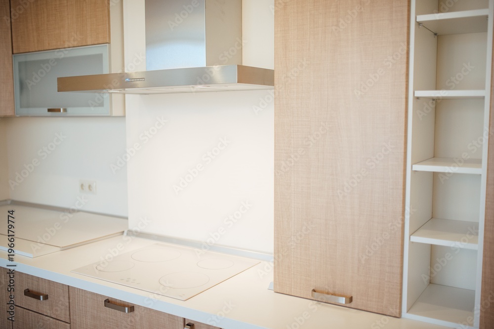 Fototapeta premium Modern kitchen interior with wooden cabinets and stainless steel appliances