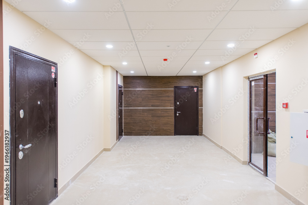 Fototapeta premium Modern hallway with doors and lighting in contemporary building interior