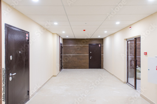 Modern hallway with doors and lighting in contemporary building interior