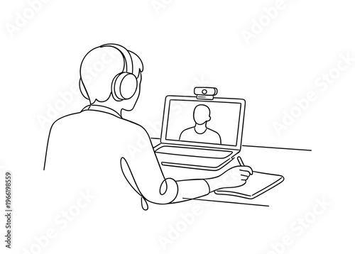 Video conference moment with person seated at a compact desk facing an open laptop, webcam positioned on top, headphones worn