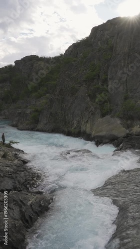 View of Azara Waterfall in Perito Moreno National Park with a man standing on the rocks in nature. Patagonia, Argentina