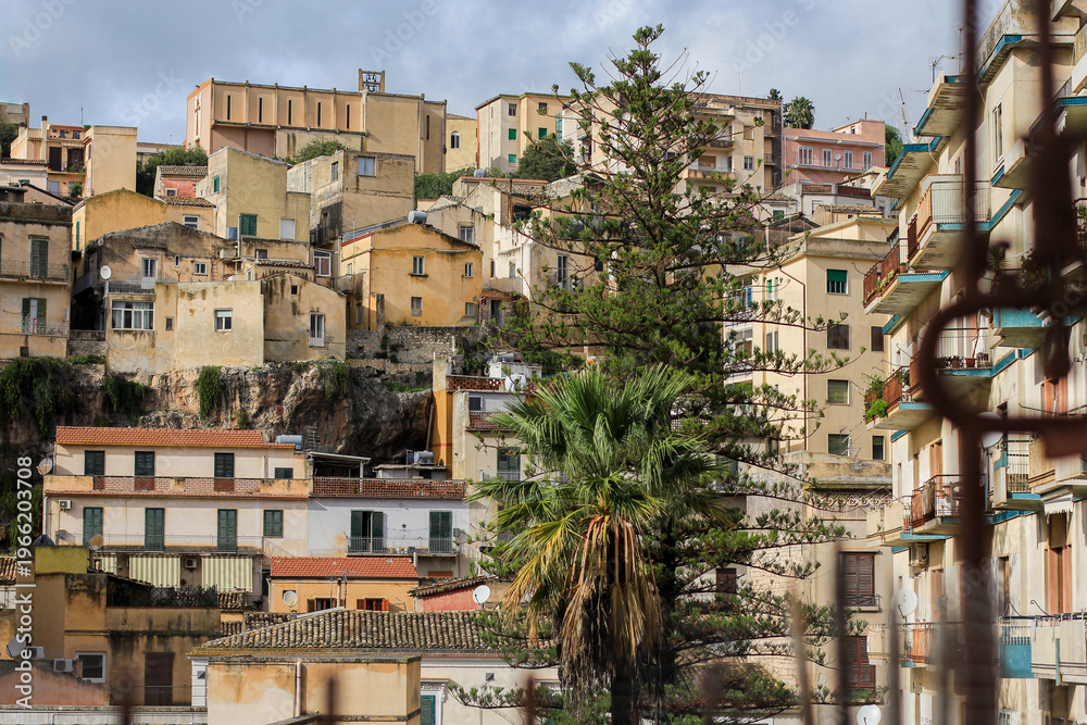 Naklejka premium Beautiful panorama of a Sicilian city, Modica, Italy, ancient architecture on a hill with typical Sicilian buildings, no people, a combination of old and new architecture, houses in the city, panorama