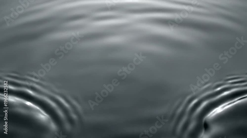 Water Droplet Creating Ripples on Surface.