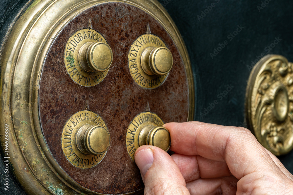 Ταπετσαρία Close-up of hand dialing combination lock on a vintage safe.