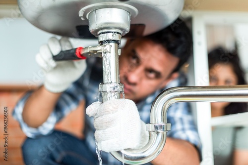 Photography Plumber fixing kitchen sink photo
