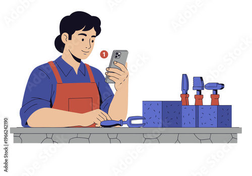 A craftsman reviews loan approval on his phone while working on a workshop bench with tools. Artisan workshop approved loan.