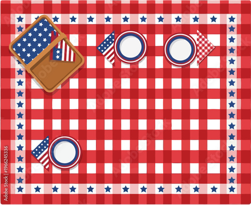 Overhead view of a red and white gingham picnic tablecloth set with plates, small flags, and an open basket for outdoor dining.