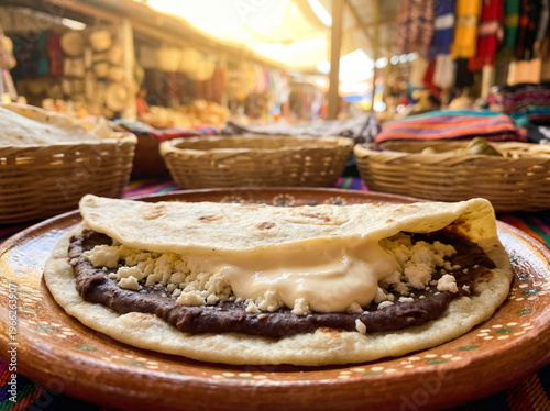 Fotografija Close-Up of Honduran Baleada Thick Flour Tortilla with Refried Beans and Cream a