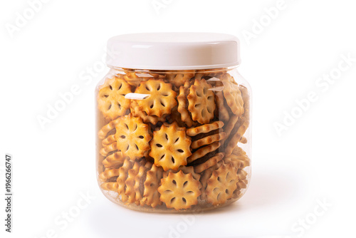 Glass jar filled with crispy golden crackers isolated on a white background. snack food, storage, freshness,  biscuits perfect for everyday consumption and convenient packaging.
