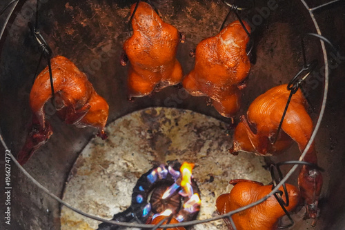 Wallpaper Mural Roasted ducks, known as bebek, being cooked on an open flame in a traditional Indonesian-style barbecue setup. Torontodigital.ca
