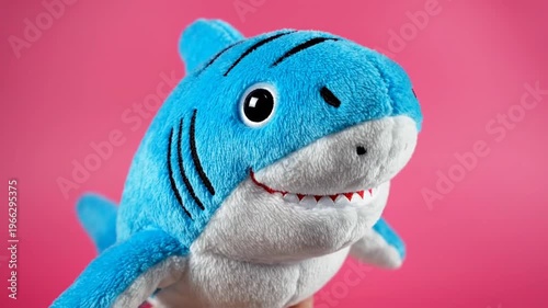 Blue Shark Plush Toy on Pink Background.