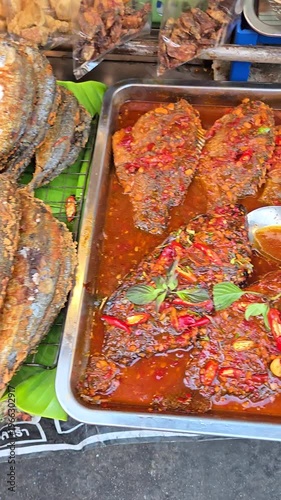  View of various kind of thai local barbeque fish and meat food at street food stall. Vertical footage