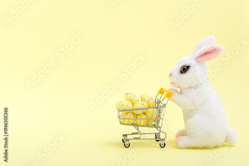 Easter bunny with an eggs in a shopping cart