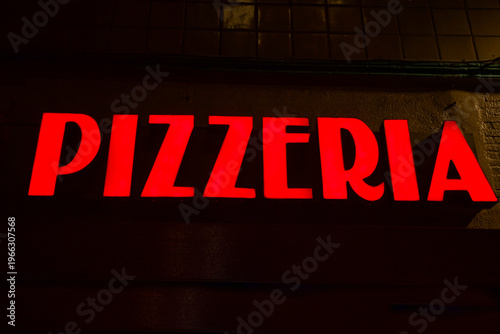Red glowing Pizzeria sign