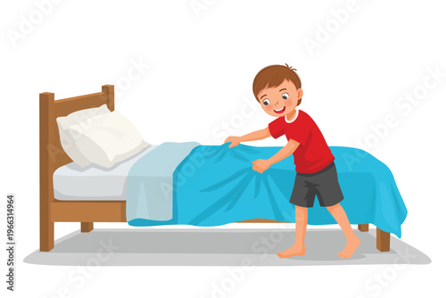 Little boy making bed in the morning