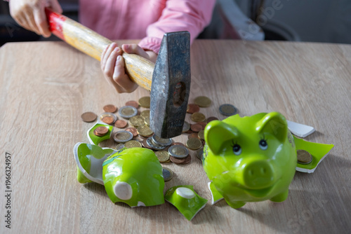 little girl breaking piggy bank with hammer, euro coins scattered on table, childhood curiosity and money concept, savings smashed open, financial habits, playful but destructive action at home