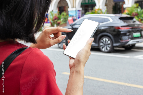 Canvastavla A young Chinese woman hailing a ride-hailing car on a city street