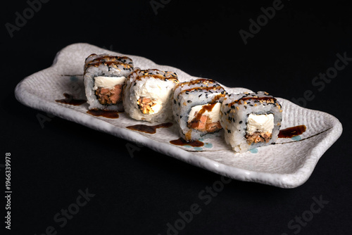 sushi rolls on black plate