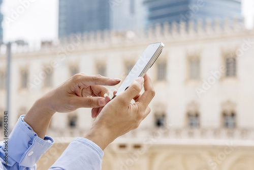 A portrait of an Eastern businesswoman, an urban white-collar worker, using her mobile phone