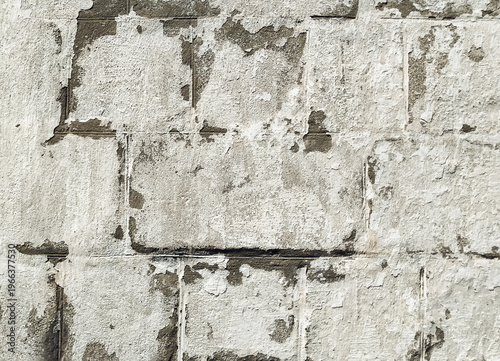 фотографія Light gray, almost white cinder block wall covered with lime chalk water-based paint
