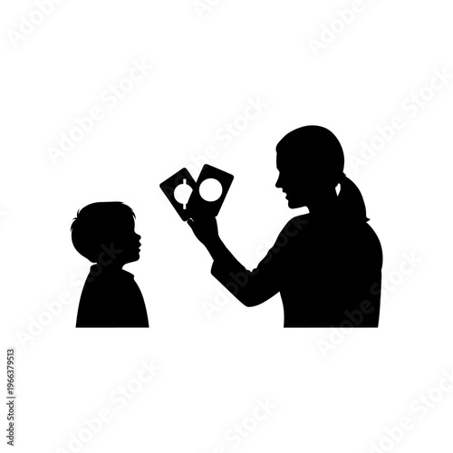 Silhouette of a Speech Therapist Holding Up Flashcards for a Child Early Intervention