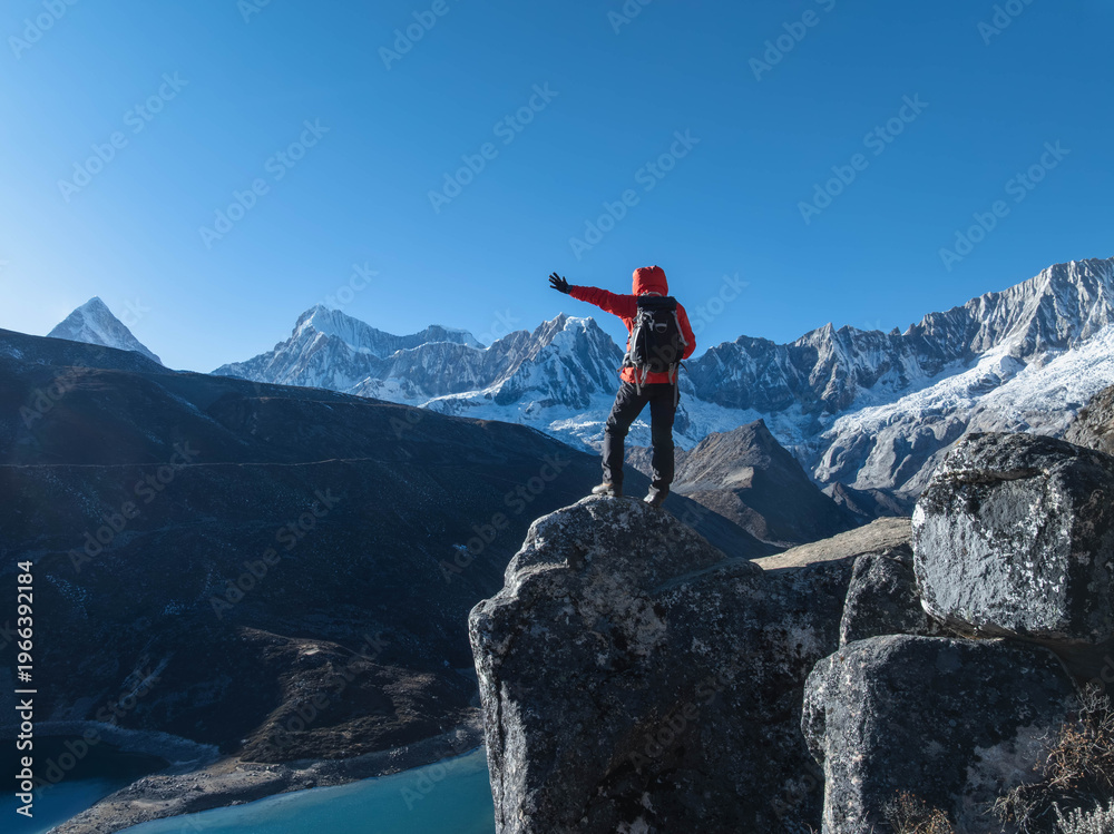 Fototapeta premium Backpacking woman hiking on high altitude mountain top