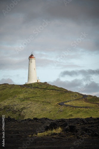 Reykjanes Lighthouse in Iceland with on the hill of peninsula. Landscape scenery, travel and tourism landmark, vertical banner