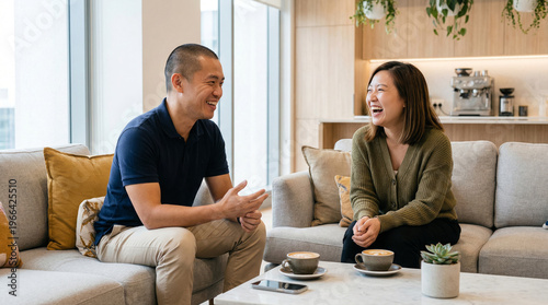 Asian Coworkers Chatting Over Coffee in Modern Office Lounge, Relaxed Workplace Lifestyle