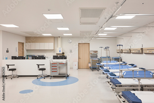 Open hospital treatment ward and corridor with bright ceilings and organized clinical layout