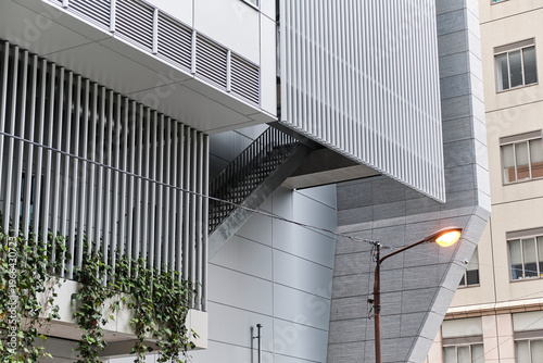 Contemporary metal facade with vertical greenery and exterior stairs detail