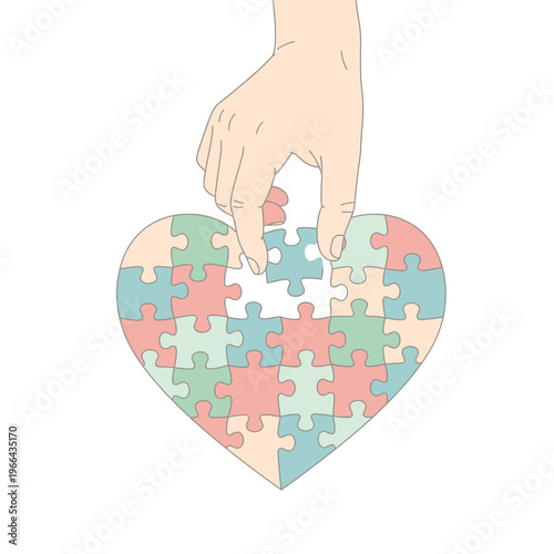 Hand placing last puzzle piece into a colorful heart shape, representing love and connection.
