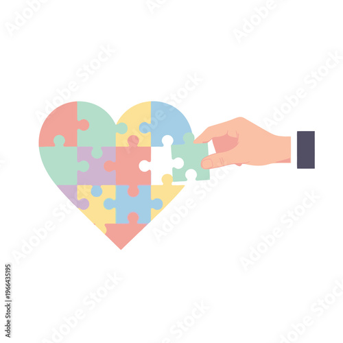 Hand placing last puzzle piece into colorful heart shape, autism awareness concept