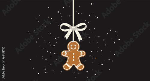 Traditional gingerbread man cookie hanging from a white ribbon with a bow against a dark background with white sparkles or snow.