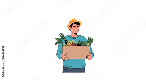 Happy young farmer wearing a hat is holding a large cardboard box filled with fresh organic vegetables from the harvest.