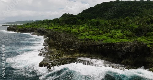 Wallpaper Mural Hillside covered with tropical trees above rugged coastline and dark blue water. Siargao, Philippines. Torontodigital.ca