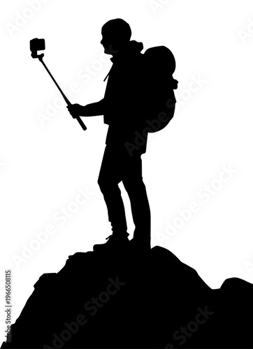Black Silhouette of a Male Backpacker on a Mountain Summit Using an Action Camera on a Selfie Stick