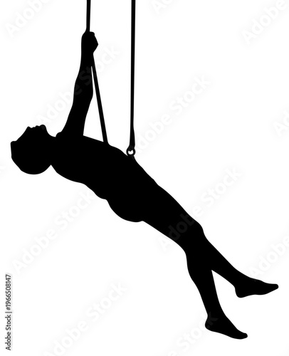 Black silhouette of a female aerialist performing on gymnastic rings isolated on white background
