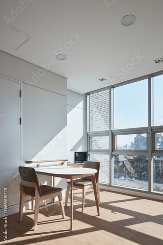 Sunlit patient lounge or examination room with table and large window