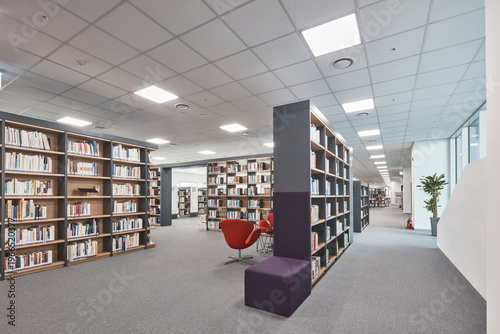 Large library floor with black shelves and bright reading zones