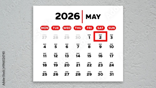 The date May 2nd marked with a red cursor on a wall calendar 2026