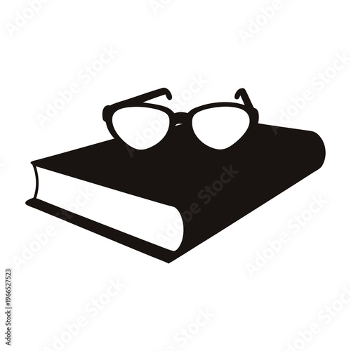 A single black book with reading glasses sitting on top of it