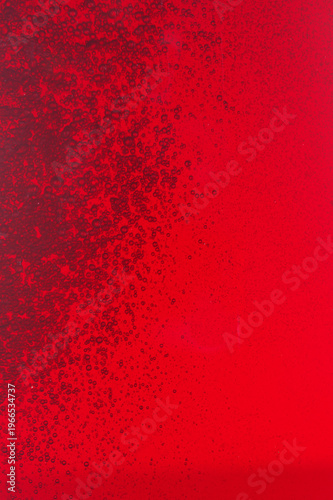 Close-up of red wine bubles in a transparent glass on black backgrond