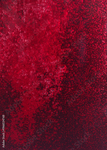 Close-up of red wine bubles in a transparent glass on black backgrond