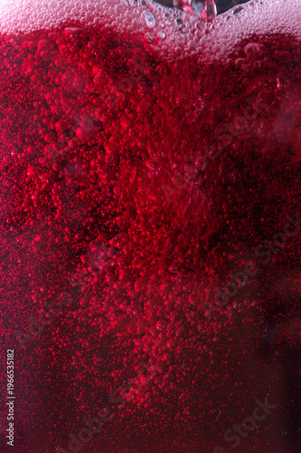 Close-up of red wine bubles in a transparent glass on black backgrond